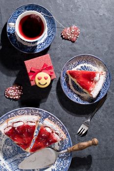 Valentines day, red strawberry pie on blue plates and a gift in a red box . High quality photo