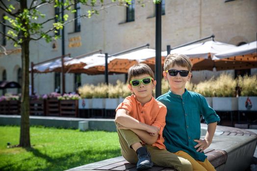 Outdoor portrait of two friends boys teenagers old talking and laughing on city street. Tourism and travel concept.