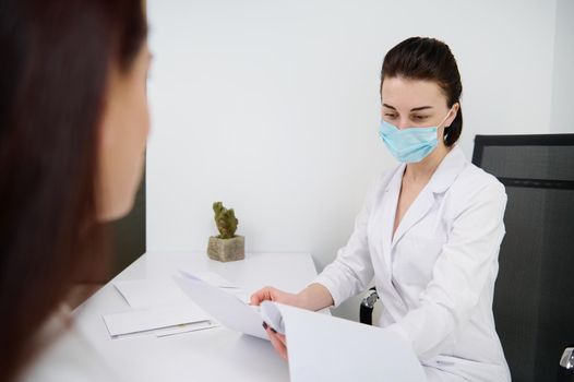 Female doctor aesthetician or general practitioner consulting a female patient in a medical clinic. Health care and medicine. Cosmetology, dermatology, beauty treatment