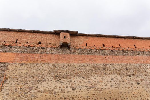 brick wall of an old castle with toilet room on the facade