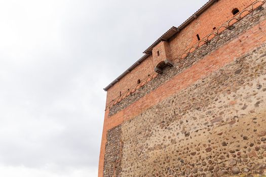 brick wall of an old castle with toilet room on the facade