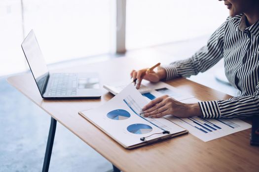 Close up Business woman hand using calculator to calculate the company's financial results and budget. Account Audit Concept