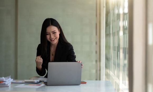 Excited asian female feeling euphoric celebrating online win success achievement result, young woman happy about good email news, motivated by great offer or new opportunity, passed exam, got a job.