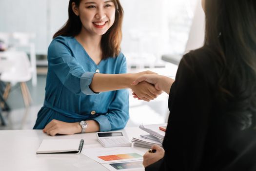 Close up of business people shaking hands, finishing up meeting, business etiquette, congratulation, merger and acquisition concept.