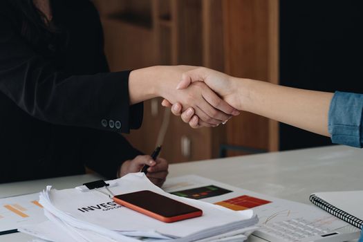 Close up of Business people shaking hands, finishing up meeting, business etiquette, congratulation, merger and acquisition concept.