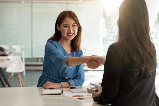 Close up of Business people shaking hands, finishing up meeting, business etiquette, congratulation, merger and acquisition concept.