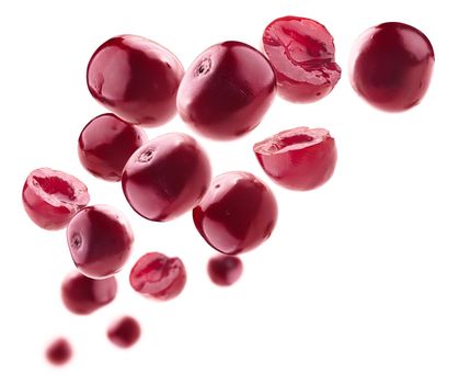 Red cherry berries levitate on a white background.