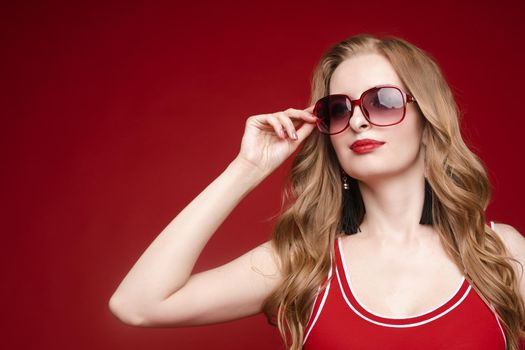 Beautiful female model posing on red background