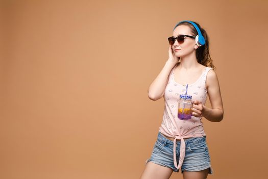 A woman in bright clothes, a T-shirt and denim shorts, sunglasses