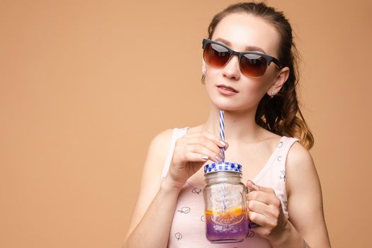 A woman in bright clothes, a T-shirt and denim shorts, sunglasses
