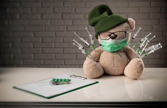 the children's vaccination against the covid19 virus and vaccinations on the example of a teddy bear