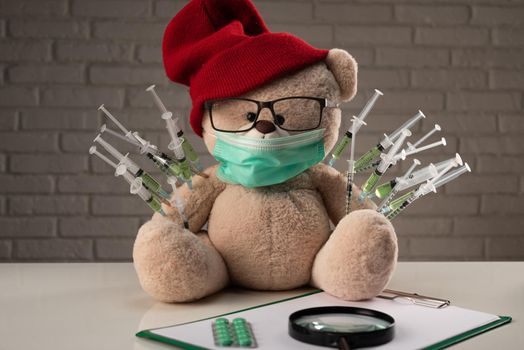 the children's vaccination against the covid19 virus and vaccinations on the example of a teddy bear