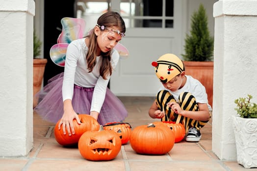 Shot of two adorable young siblings playing together on Halloween at home.