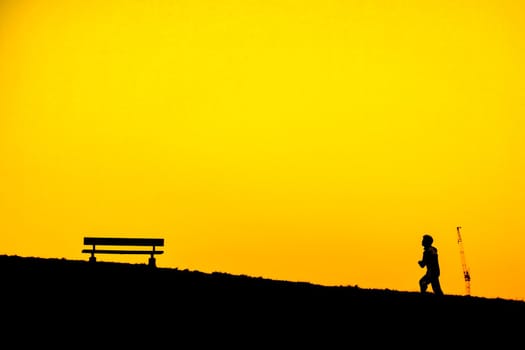 Silhouette of people sitting on the hill at dusk. Shooting Location: Mitaka City, Tokyo