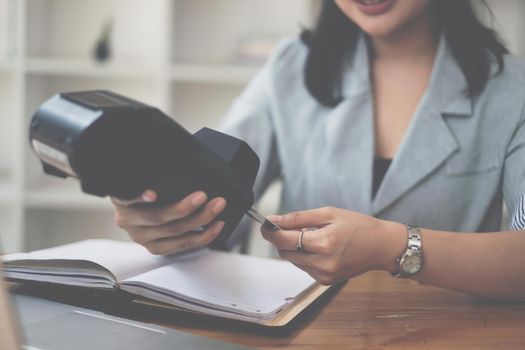 Hand of woman do Payment with credit card reader machine