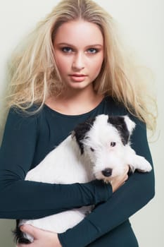 Portrait of a gorgeous young woman holding her adorable dog.