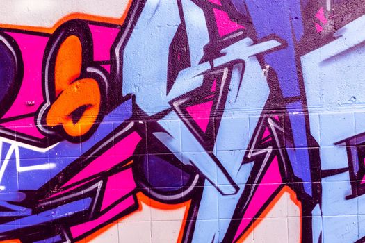 Detail of a purple graffiti on a wall, abstract background