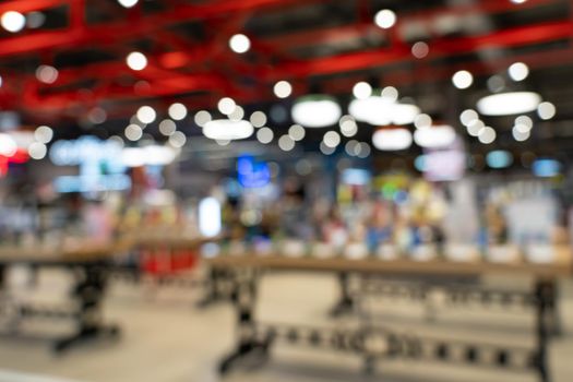 Showcase with smartphones in the modern electronics store. Buy a mobile phone. Many smartphones on the shelf of the technology store. Blurred image as a background.