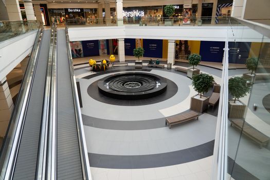 Grodno, Belarus - April 07, 2021: View of the travolators in modern shopping center Triniti. A stepless escalator facilitates the movement of people from the first to the second floor.