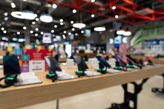 Showcase with smartphones in the modern electronics store. Buy a mobile phone. Many smartphones on the shelf of the technology store. Blurred image as a background.