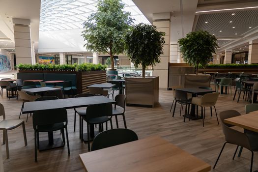 Interior of wooden table in food court shopping mall. Food center in department store.