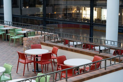 View on food court zone near by the ice rink in modern shopping mall. Food center in department store.