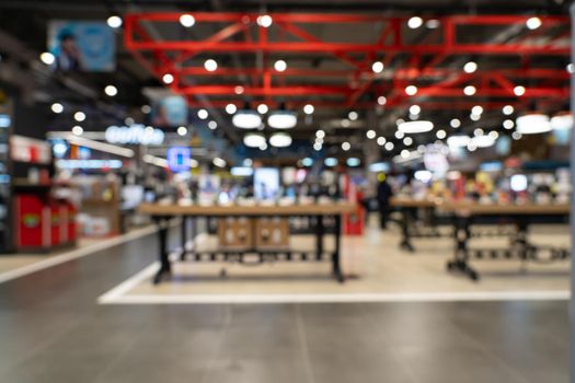 Showcase with smartphones in the modern electronics store. Buy a mobile phone. Many smartphones on the shelf of the technology store. Blurred image as a background.