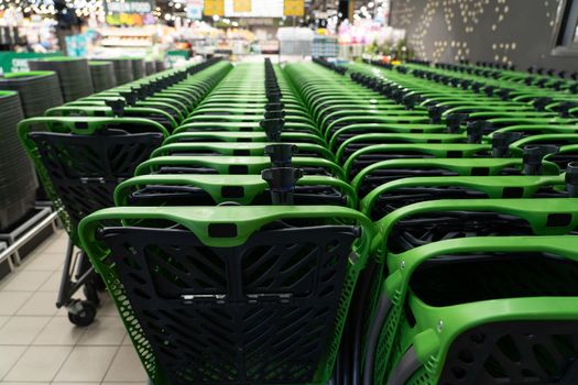 Shopping carts in a hypermarket close-up. Extremely shallow depth of field, selective focus.