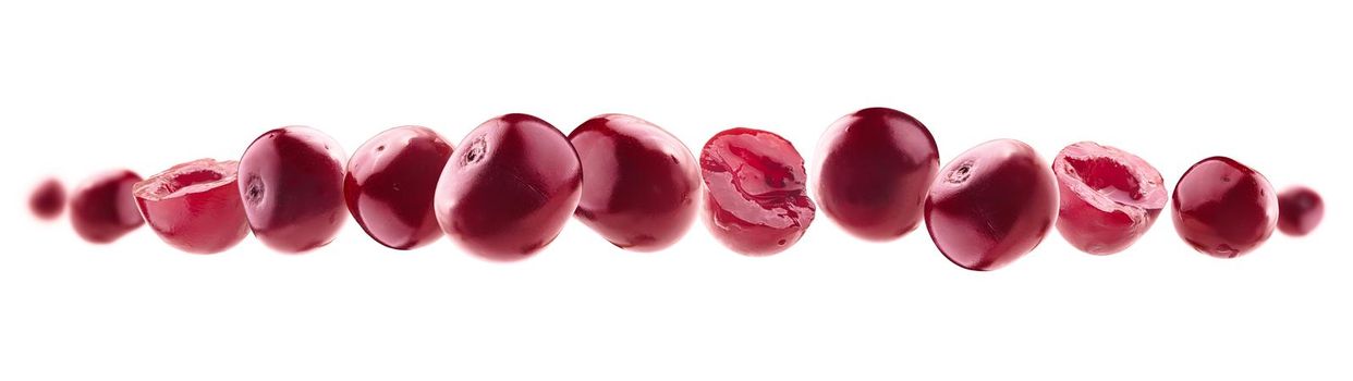 Red cherry berries levitate on a white background.