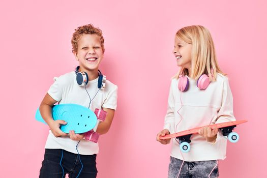 boy and girl stand next to skateboards isolated background. High quality photo