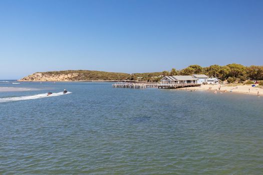 The idyllic Barwon River Beach and Barwon Heads Bridge on a hot summer's day in Barwon Heads, Victoria, Australia