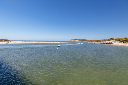 The idyllic Barwon River Beach and Barwon Heads Bridge on a hot summer's day in Barwon Heads, Victoria, Australia