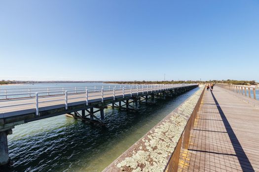 The idyllic Barwon River Beach and Barwon Heads Bridge on a hot summer's day in Barwon Heads, Victoria, Australia