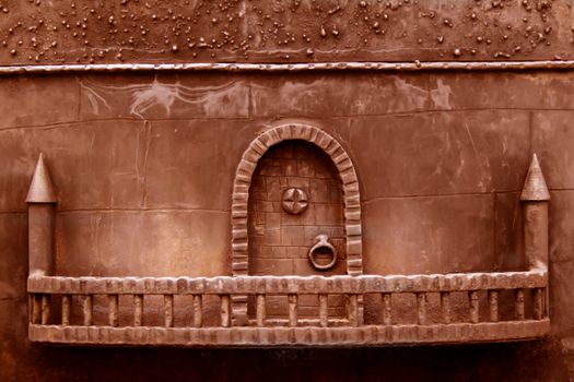 Background rusty toy medieval wall with door.