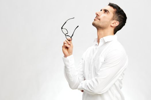 handsome businessman white shirt posing hand gesture spectacled looking up. High quality photo