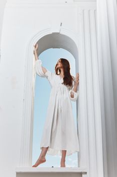 portrait of a woman in a white dress window opening luxury romance. High quality photo