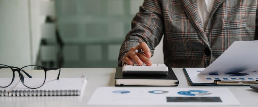 Close up view of bookkeeper or financial inspector hands making report, calculating or checking balance. Home finances, investment, economy, saving money or insurance concept.