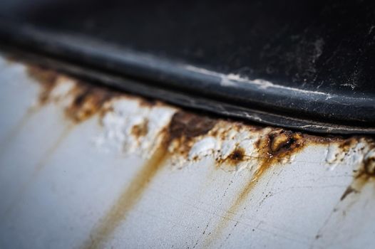 Close-up of rust on a white car