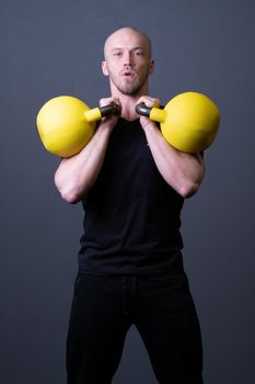 Guy with a yellow kettlebell gym anonymous young man, for motivation teenager in men and floor weightlifting, southeast activity. Healthy bent health, building hiit