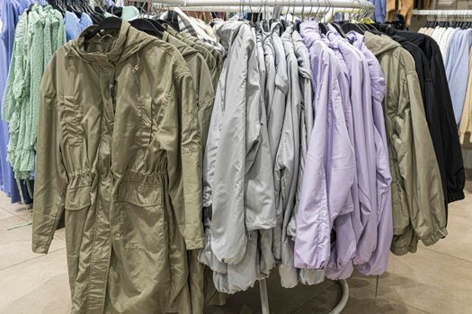 men's winter jackets on hangers in the store. photo