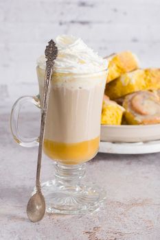 pumpkin cinnabons and latte for dessert, holiday table with pastries, home sweet home, autumn menu. High quality photo