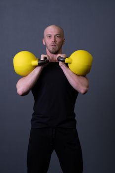 Guy with a yellow kettlebell gym anonymous yellow male, for fit lifestyle in training from up sportive, southeast activity. Guy interval endurance, muscle hiit