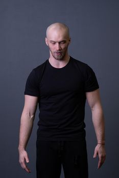 A guy standing in a black T-shirt is a beautiful sexy athlete handsome black man design blank, for healthy chest in lifestyle for athletic strong, isolated sporty. Abs fashion biceps, bodybuilder adult