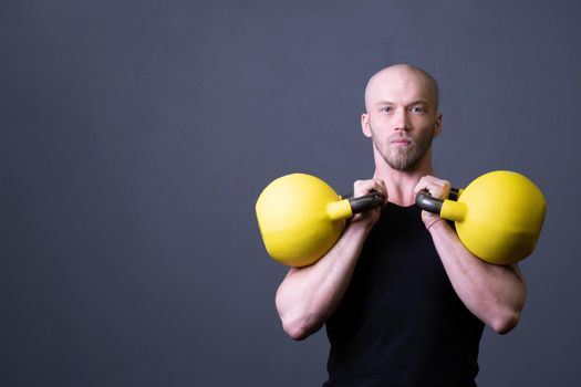 Guy with a yellow kettlebell gym anonymous yellow man, in the afternoon sporty effort from painted from floor youth, malaysian fitness. Guy down health, building hiit