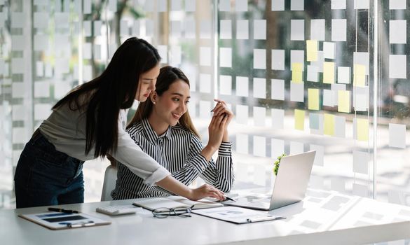 Businessman and business woman discuss to working with using laptop computer and for searching information stock market chart for trading to Make a profit. Planning and Investment concept