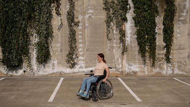 Woman riding a wheelchair in a parking lot