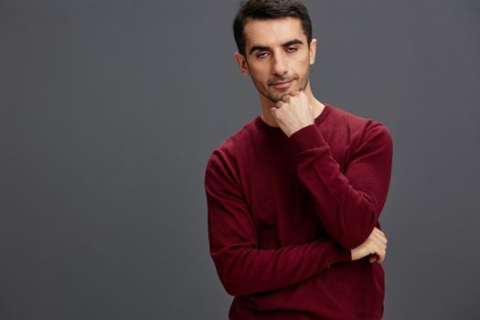 handsome man posing gesture hands red sweater cropped view. High quality photo