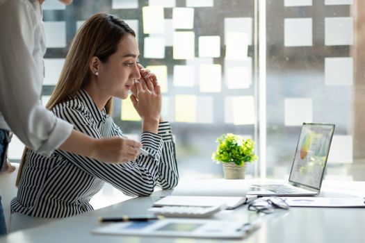 Businessman and business woman discuss to working with using laptop computer and for searching information stock market chart for trading to Make a profit. Planning and Investment concept