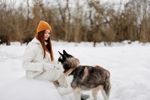 woman winter clothes walking the dog in the snow fresh air. High quality photo
