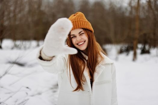 woman red hair walk in the fresh winter air Walk in the winter forest. High quality photo